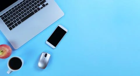 Blue office desk table with computer and morning snacks. Stock Photos