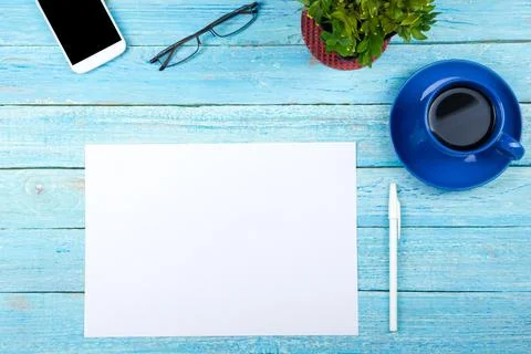 Blue Office desk table with computer, pen and a cup of coffee, lot of thing.. Stock Photos
