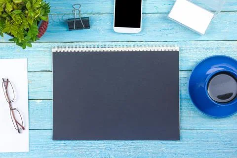 Blue Office desk table with computer, pen and a cup of coffee, lot of thing.. Stock Photos
