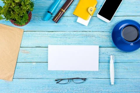 Blue Office desk table with computer, pen and a cup of coffee, lot of thing.. Stock Photos
