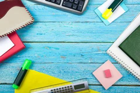Blue office desk table with computer, pen and a cup of coffee, lot of things. Stock Photos
