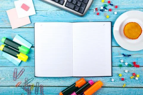 Blue office desk table with computer, pen and a cup of coffee, lot of things. Stock Photos