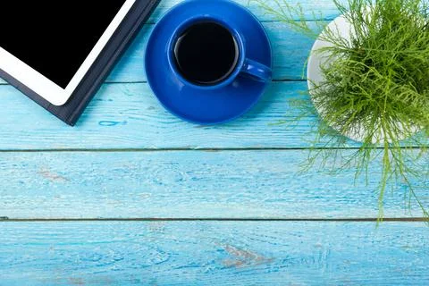 Blue office desk table with computer, pen and a cup of coffee, lot of thing.. Foto stock