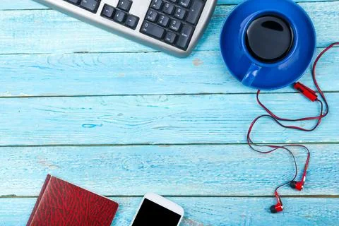 Blue office desk table with computer, pen and a cup of coffee, lot of things. Stock-Fotos