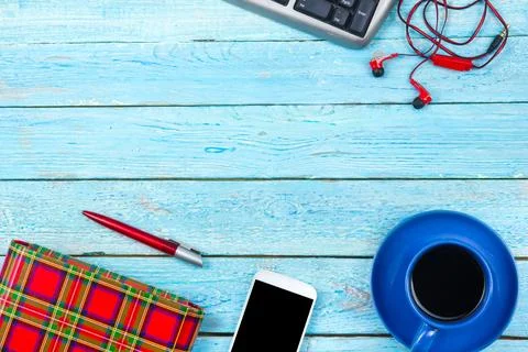 Blue office desk table with computer, pen and a cup of coffee, lot of things. Stock Photos