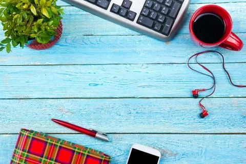 Blue office desk table with computer, pen and a cup of coffee, lot of thing.. Stock-Fotos