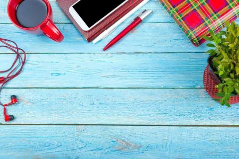 Blue office desk table with computer, pen and a cup of coffee, lot of things. Stock Photos