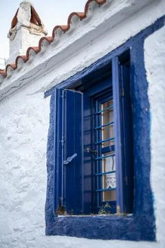 Blue open window on white wall of greek house. Stock-Fotos