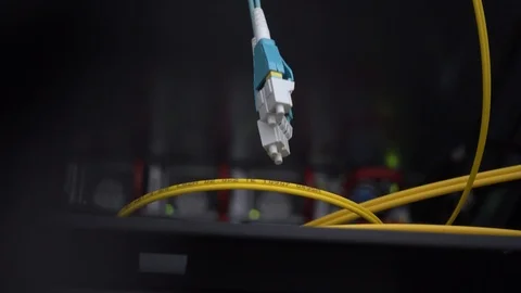 Blue optical cable dangles in a server rack Stock Footage 122029153