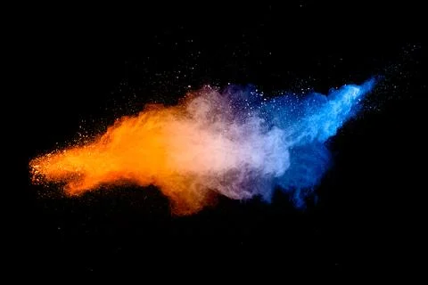 Blue  orange color powder explosion cloud on black background. Stock Photos