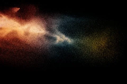 Blue orange particles explosion on black background.Colorful dust splash. Stock Photos