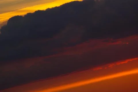 Blue-orange sky with clouds at sunset, at an angle. Stock Photos