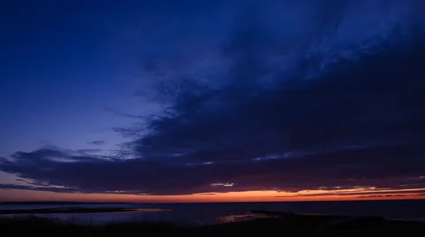 Blue orange sky in a midsummer night at the coast of Torekov in Sweden 29.97 FPS Stock Footage 51384468