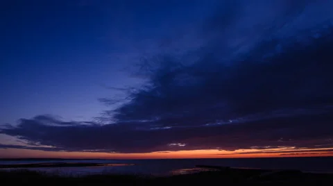 Blue orange sky in a midsummer night at the coast of Torekov in Sweden Stock Footage 51384893