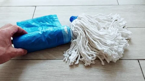 Blue Packages, White Mop: Fast DIY Floor Cleaning with Everyday Items Video stock 312733354