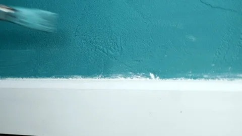 Blue paint is applied on a wall next to a skirting board 動画素材 101166078