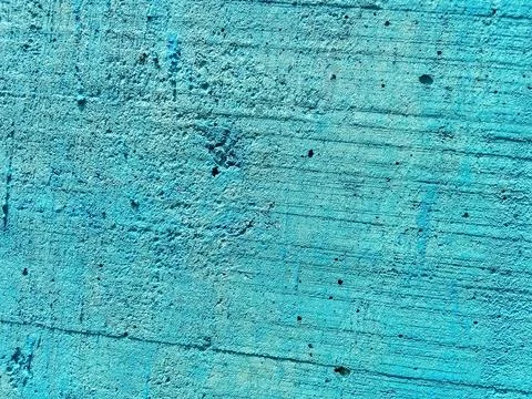 Blue paint background, rough texture of concrete wall. Фото