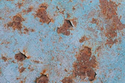 Blue paint flaking and cracking texture on rusty metal. Stock Photos