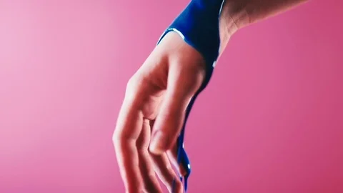 Blue paint flows down on the arm Stock Footage 81702060