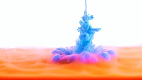 Blue paint ink flows into Orange in water Stock Footage 121688104