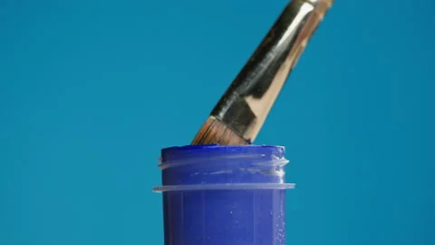 Blue paint isolated on background. Bright gouache falling from paintbrush close Stock Footage 178604913
