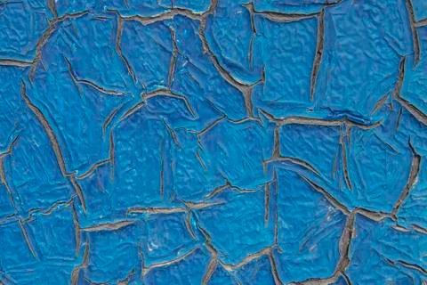 The blue paint on the metal cracked from the effects of natural phenomena, te Stock Photos