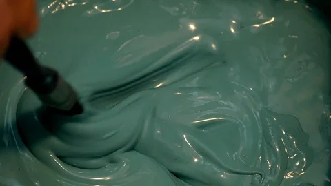 Blue paint is mixed using a paint brush Stock-Footage 100975398