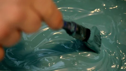 Blue paint is mixed using a paint brush Stock-Footage 101165832
