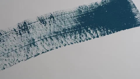 Blue paint painted onto wall with brush Stock Footage 260345714