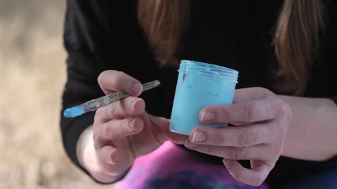 Blue paint in a plastic container. Brush for painting. Stock Footage 120463721