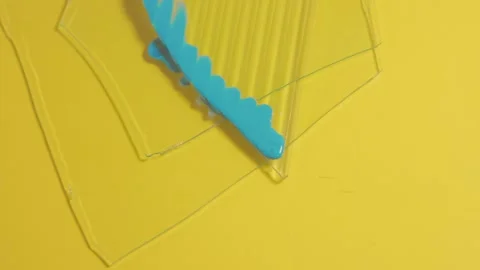 Blue paint pour on clear acrylic over yellow background, abstract close-up Stock Footage 316612864