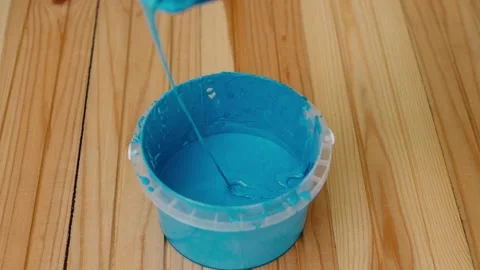 The blue paint is poured a bucket. Stock Footage 201266088