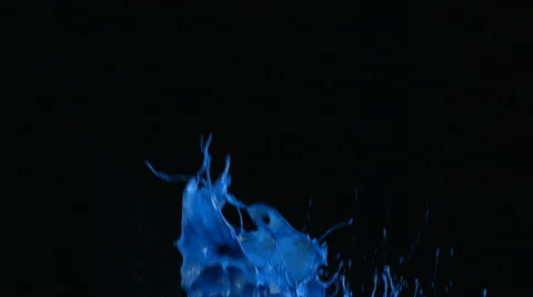Blue paint splattering on black background, slow motion Stock Footage 61676393