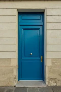 Blue painted door in classical building facade, Paris, France, representing.. Stock Photos
