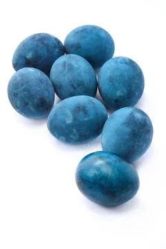 Blue painted eggs on a white background, vertical shot Stock Photos