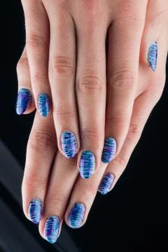 Blue painted nails and hands isolated on black background Stock Photos