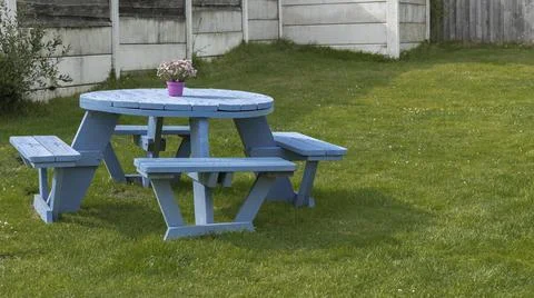 Blue painted table in a garden Stock Photos