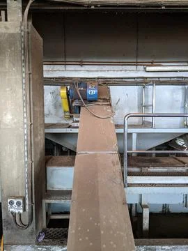 A blue palm kernel intake conveyor motor located in a palm kernel processing Stock Photos