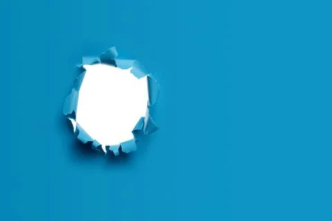 Blue paper background with torn hole Foto stock