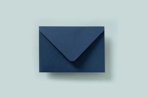 Blue paper envelope on blue background. View from above. Stock Photos
