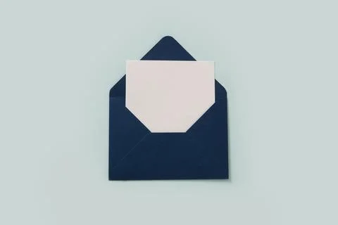 Blue paper envelope on blue background. View from above. Stock Photos