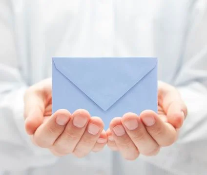 Blue paper envelope in hands Stock Photos
