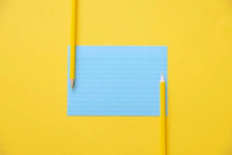 Blue paper note and two pencils Stock Photos
