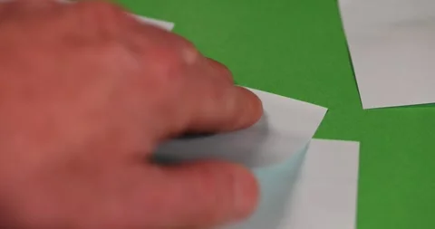 Blue paper for notes on green paper, stationery made of thin paper with glue on Stock Footage 327044012