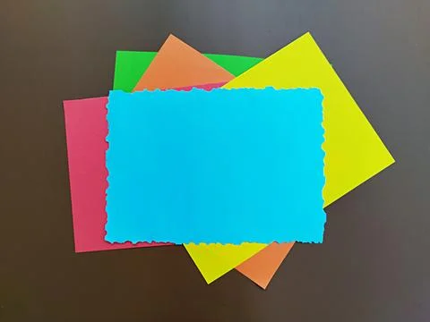 Blue paper torn at the edges with a layer of colored paper Foto stock
