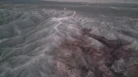 Blue paraglider kite flying over remote rock formations in Utah landscape; Stock Footage 274868678
