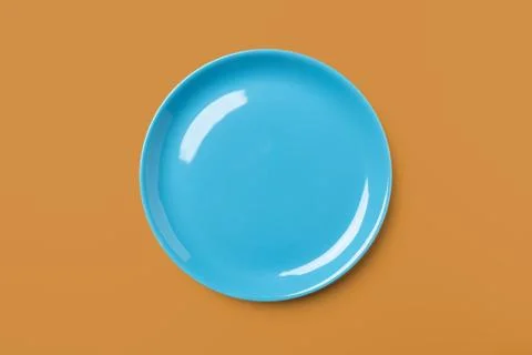 Blue pastel colored plate on complementary background, Stock Photos