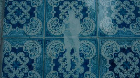 Blue pattern with a human sticker on tiles in Lisbon city Portugal 2017 Stock Photos