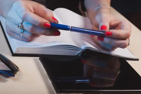 Blue pen in hand Stock Photos