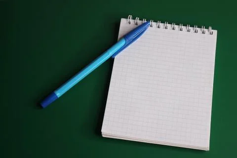 Blue pen is located on the notebook. Empty space to insert text. Stock Photos